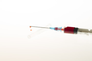 Fototapeta premium Close up view of Syringe needle with drops Blood. Medicine. Medicine Injection. Medicine concept. Intravenous or Inektion with Blood Addiction, Drug Dependence.