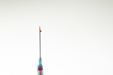 Close up view of Syringe needle with drops Blood. Medicine. Medicine Injection. Medicine concept....