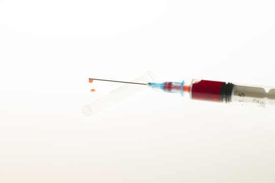 Close up view of Syringe needle with drops Blood. Medicine. Medicine Injection. Medicine concept. Intravenous or Inektion with Blood Addiction, Drug Dependence.