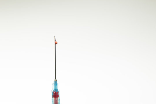 Close up view of Syringe needle with drops Blood. Medicine. Medicine Injection. Medicine concept. Intravenous or Inektion with Blood Addiction, Drug Dependence.