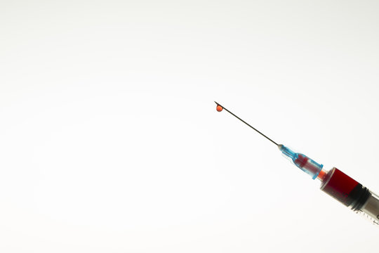 Close up view of Syringe needle with drops Blood. Medicine. Medicine Injection. Medicine concept. Intravenous or Inektion with Blood Addiction, Drug Dependence.