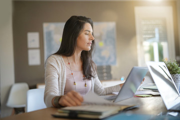 Businesswoman in office working on laptop