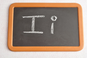 Fototapeta na wymiar A black board with the alphabet letter I in a capital and small letter
