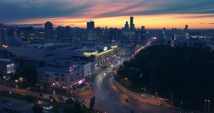 Aerial view night city traffic and dark urban skyline beautiful sunset 4K UHD