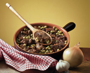 crock pot with stew and peas
