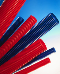 red and blue plastic tubes on light blue background
