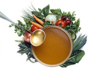 pan of vegetable soup with ingredients around it
