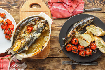 mackerel with roasted tomatoes and bread on wooden background. The view from the top.