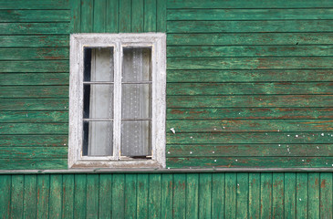 Obraz na płótnie Canvas The old window of old wooden house. Background of wooden walls