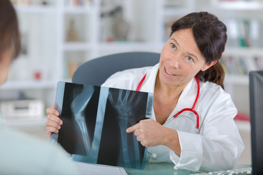 doctor shows a patient x-ray image