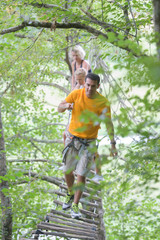 Naklejka na ściany i meble family climbing rope at the adventure park