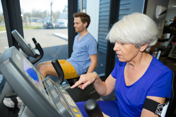 beautiful fit senior woman in gym doing cardio work out