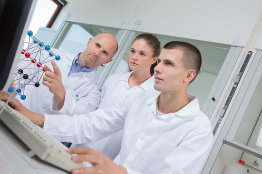 young scientists holding dna model in laboratory