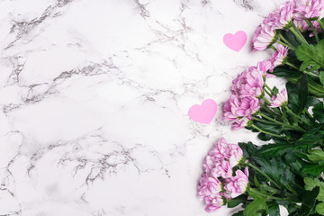 Pink flowers on marble background with copy space