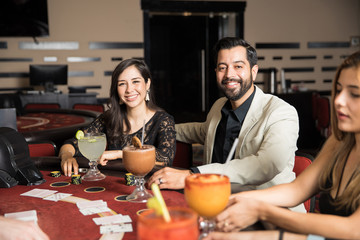 Happy couple playing cards in a casino