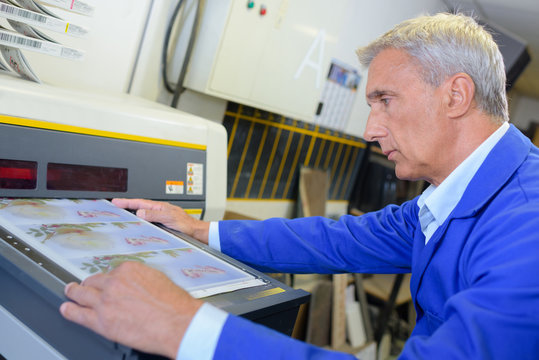 Man preparing industrial printer
