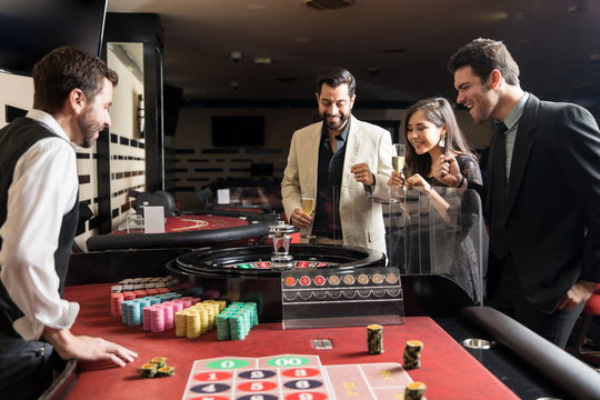 Friends playing the roulette in a casino