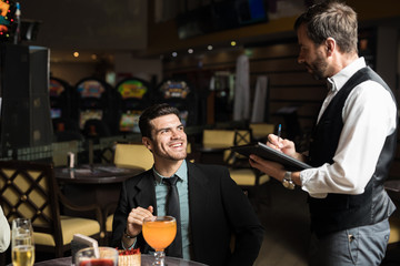 Man ordering food in a casino