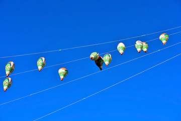 small hot-air balloons in the blue sky