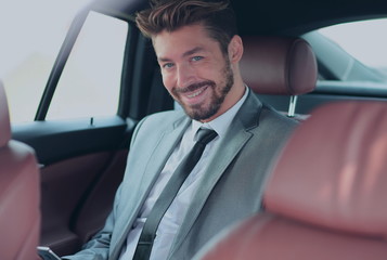 Fototapeta na wymiar Portrait of a successful business man in his car