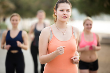 Cheerful young women during racewalking training