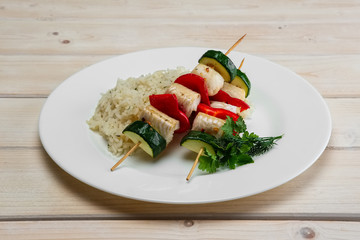 Grilled fish and vegetables on skewer with boiled rice