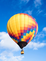 Colorful hot air balloon flying in the bright blue sky during Winthrop Balloon Festival in Washington state