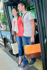 Couple getting off a bus