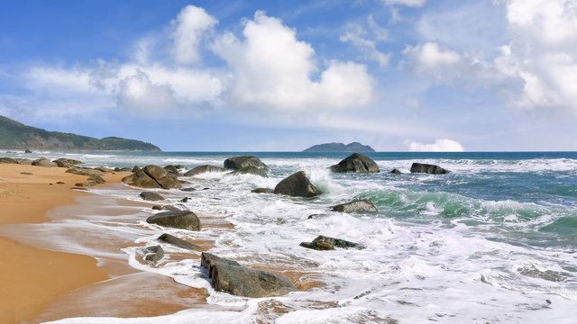 Seashore with rocks and waves at tropical Sanya, Hainan Island, China
