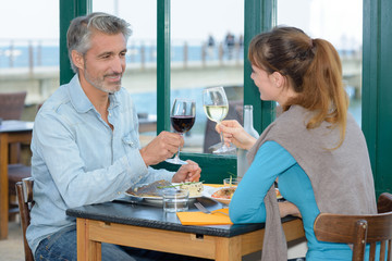 Man and lady toasting with wine glasses