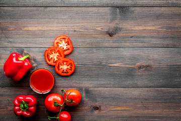 Red detox beverage with paprika and tomatoes on dark wooden background top view copyspace