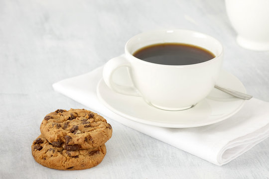 Cup of coffee and cookies on the table.