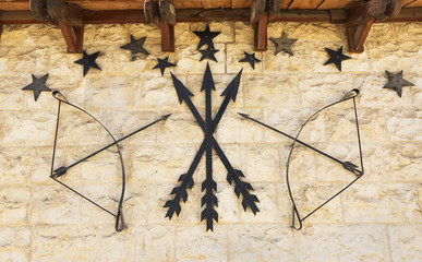  stone wall with arrows and a bow
