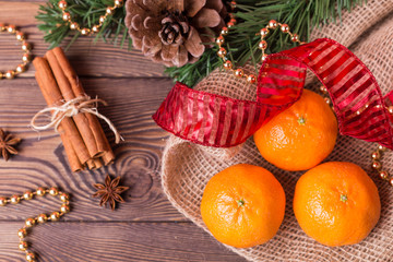 Christmas background - vintage wood, cinnamon, star anise, sweet mandarins, a New Year's decor.Top view, blank space