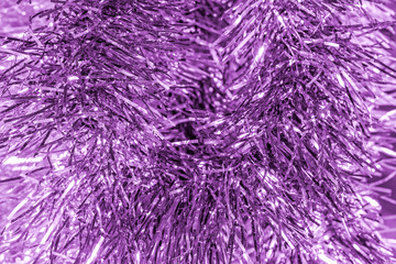 New year lilac background of tinsel, close-up