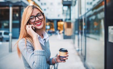 Business woman drinking coffee and talking on a mobile phone outdoor. Business, education, lifestyle concept