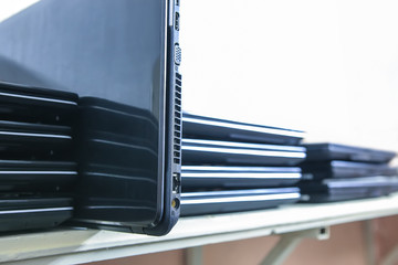 A stack of laptops. Closeup
