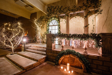 the scenery of the Studio or theater. Entrance in an old architecture with staircase and columns. Christmas decoration with garlands and fir branches