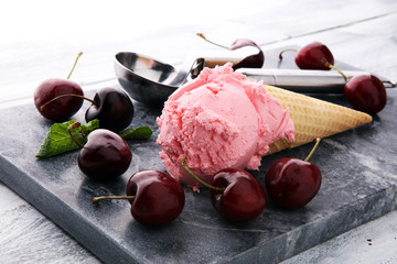 Homemade cherry ice cream on wooden background with fresh cherries