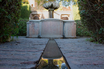 Fototapeta na wymiar Fountain. Ancient Arabic fountain. Alcazaba of Málaga, Andalusia, Spain.