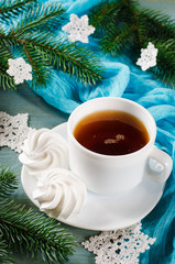 Delicious meringue cookies and cup of hot tea.