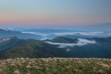 Fototapeta premium The formation and movement of clouds over the summer slopes of Adygea Bolshoy Thach and the Caucasus Mountains