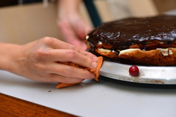 Female chef making caramel cake with strawberries