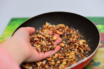 Whole walnuts in a bowl closeup. Whole walnuts, halves of nuts and walnut leaves.