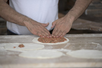 Man Preparing Lahmacun Dough With Hands on the Kitchen Desk