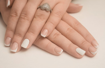 Light manicure in light on a white background.