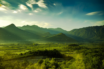 Beautiful natural scenery with sun rays and green mountains in Montenegro