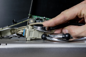 Computer treatment on a computer service. Repair and diagnostics of computer hardware. Computer equipment on a workshop table.