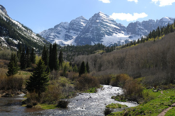 Maroon Creek - Spring time, Maroon Creek, filled with melt-water, rushing down from the side of famous Maroon Bells mountains, part of Elk Mountain, Aspen, Colorado, USA.