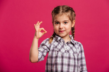 Happy cute little girl child showing okay gesture